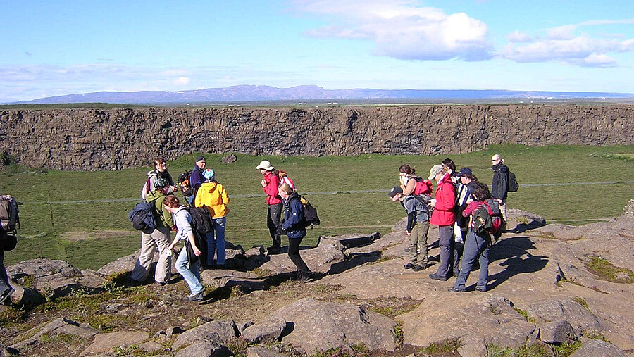 A group hikes on a rocky hill in Ireland.