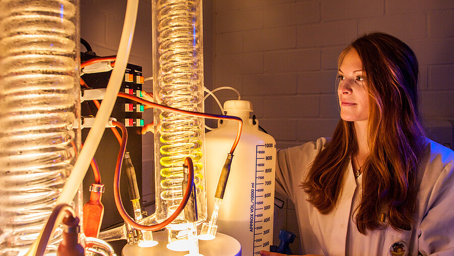 A person operates a device in a laboratory.